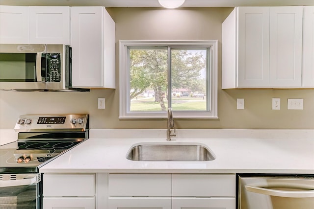 2365 Middlebelt Rd, West Bloomfield, MI 48324 - kitchen featuring stainless steel appliances, a sink, and white cabinetry