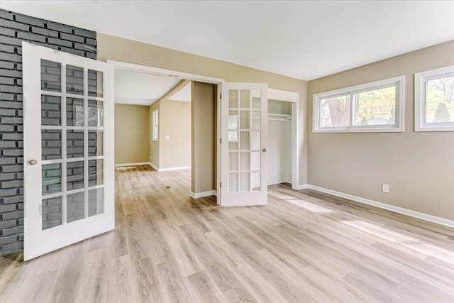 2365 Middlebelt Rd, West Bloomfield, MI 48324 - unfurnished room featuring french doors, wood finished floors, and baseboards