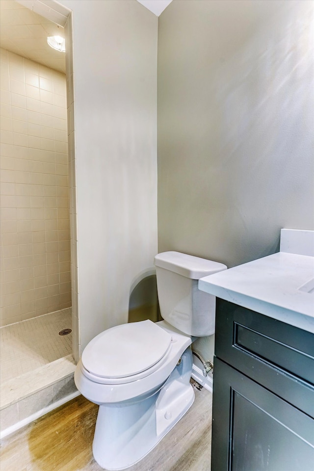 2365 Middlebelt Rd, West Bloomfield, MI 48324 - full bathroom featuring toilet, wood finished floors, a tile shower, and vanity