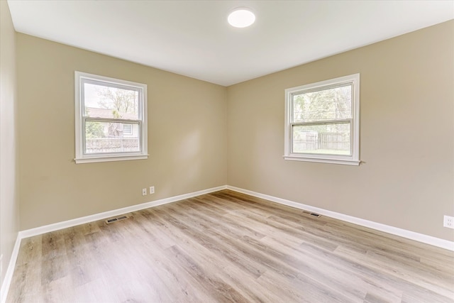 2365 Middlebelt Rd, West Bloomfield, MI 48324 - spare room featuring healthy amount of natural light, light wood-type flooring, and baseboards