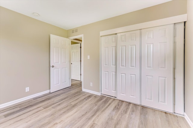 2365 Middlebelt Rd, West Bloomfield, MI 48324 - unfurnished bedroom with light wood-type flooring, baseboards, and a closet