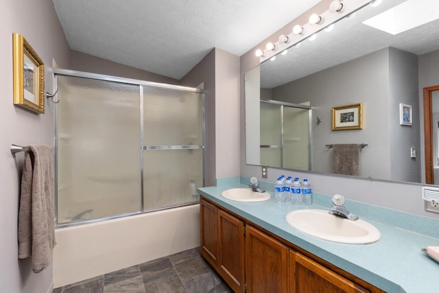 880 W Ave, Big Rapids, MI 49307 - bathroom with a textured ceiling, double vanity, bath / shower combo with glass door, a skylight, and vaulted ceiling