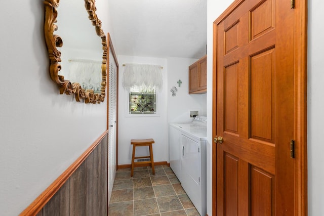 880 W Ave, Big Rapids, MI 49307 - laundry room with cabinet space, washing machine and clothes dryer, stone finish flooring, and baseboards