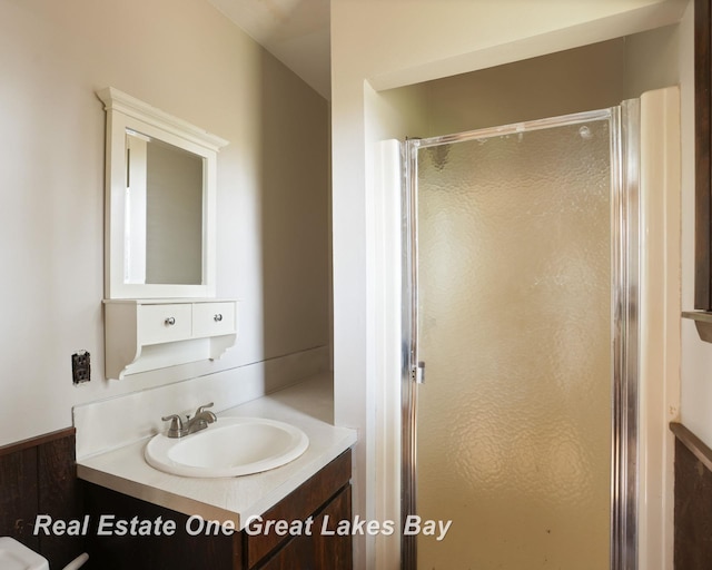 bathroom featuring a stall shower and vanity