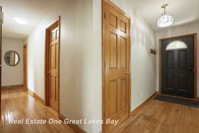 entryway featuring light wood-type flooring and baseboards