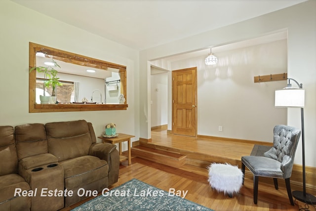 living area with wood finished floors and baseboards