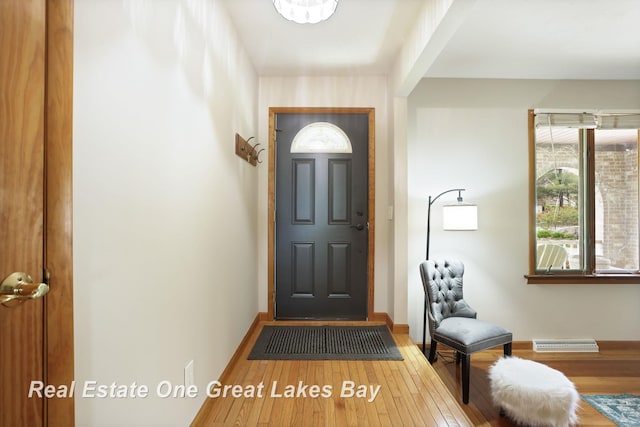foyer entrance featuring wood finished floors and baseboards
