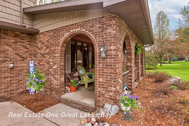 doorway to property with brick siding