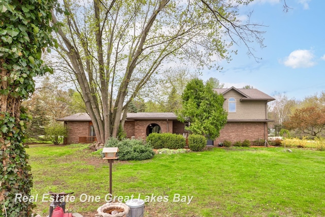 view of front of property with brick siding and a front lawn