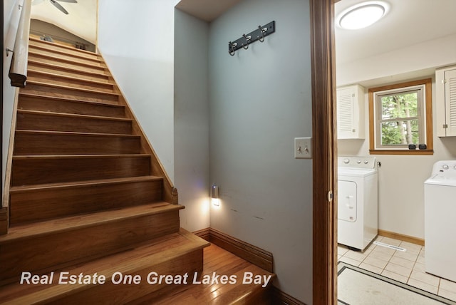 stairs featuring washer and dryer, baseboards, and tile patterned flooring