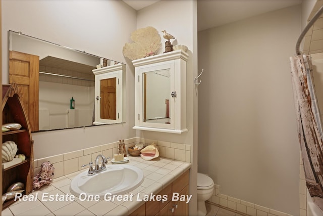 bathroom with toilet, tile patterned floors, vanity, and a shower with curtain