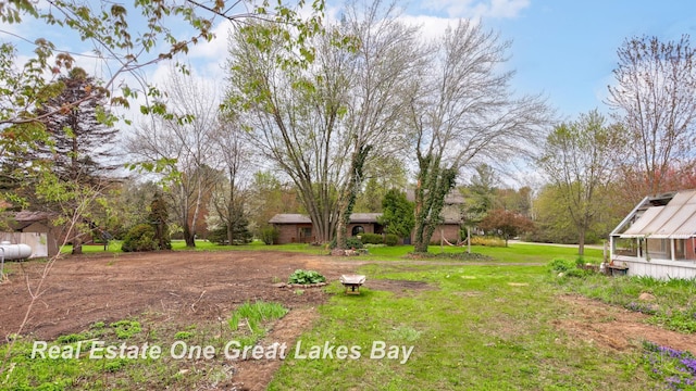 view of green lawn featuring an exterior structure and an outdoor structure