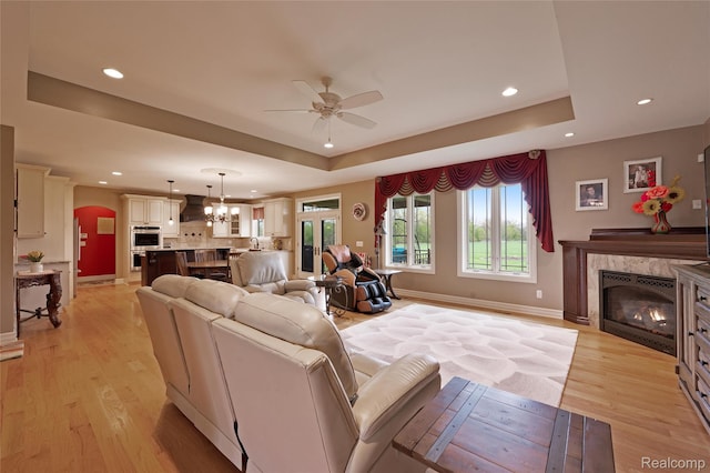 6100 30 Mile Rd, Washington, MI 48095 - living area with a raised ceiling, a ceiling fan, recessed lighting, a fireplace, and light wood finished floors