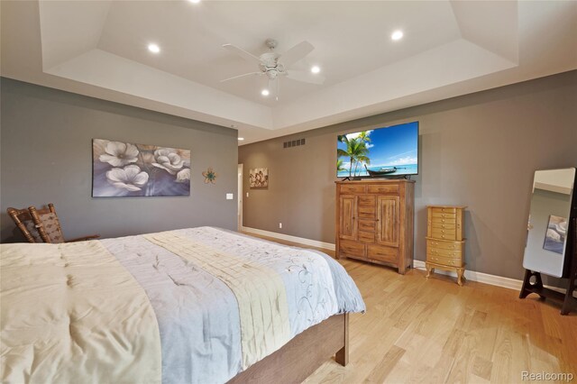 6100 30 Mile Rd, Washington, MI 48095 - bedroom featuring a tray ceiling, light wood-type flooring, recessed lighting, baseboards, and ceiling fan