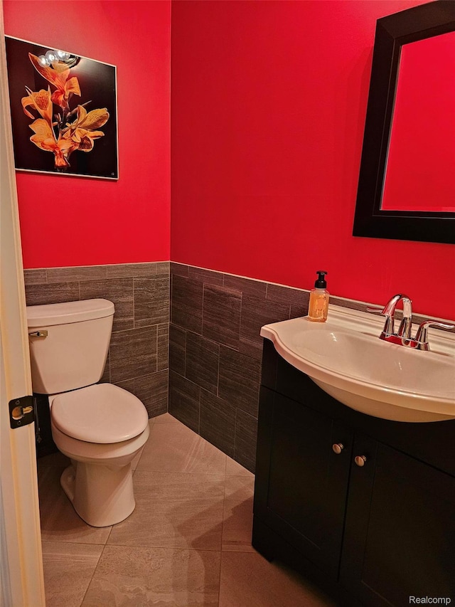 6100 30 Mile Rd, Washington, MI 48095 - bathroom with toilet, vanity, tile walls, a wainscoted wall, and tile patterned flooring
