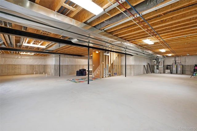 6100 30 Mile Rd, Washington, MI 48095 - unfinished basement with stairs and gas water heater