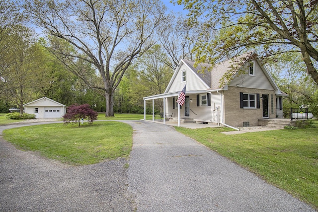 view of front of house with a front yard, a garage, brick siding, and driveway