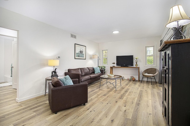 living room with light wood-style floors, recessed lighting, and baseboards