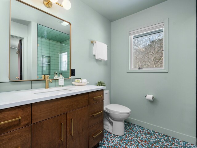 1330 N Orchard Dr, Traverse City, MI 49686 - full bathroom with toilet, vanity, a shower with shower door, baseboards, and tile patterned floors