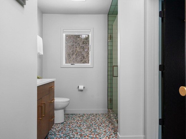 1330 N Orchard Dr, Traverse City, MI 49686 - full bath featuring toilet, vanity, a shower with door, and baseboards