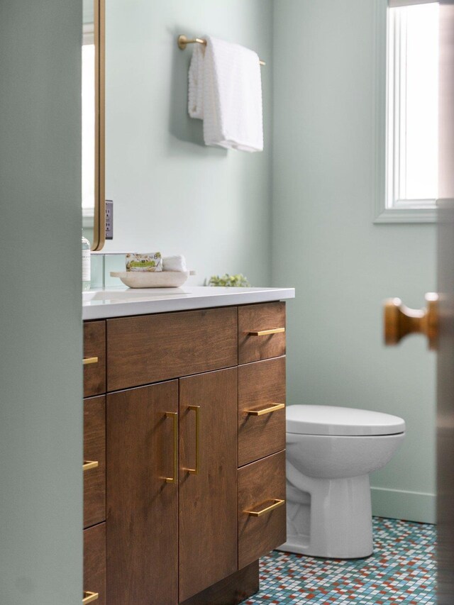 1330 N Orchard Dr, Traverse City, MI 49686 - bathroom with vanity, toilet, tile patterned floors, and baseboards