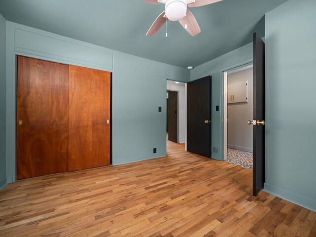 1330 N Orchard Dr, Traverse City, MI 49686 - unfurnished bedroom featuring wood finished floors, a closet, and ceiling fan
