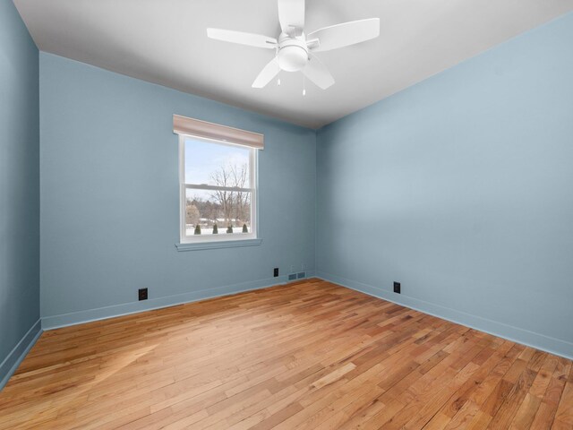 1330 N Orchard Dr, Traverse City, MI 49686 - empty room featuring light wood-style floors, a ceiling fan, and baseboards