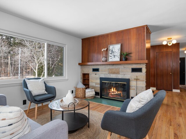 1330 N Orchard Dr, Traverse City, MI 49686 - living area featuring a fireplace, light wood finished floors, and baseboards