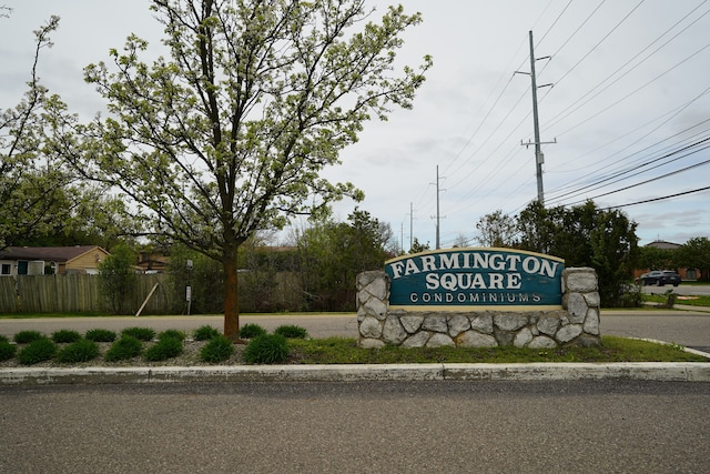 community / neighborhood sign with fence