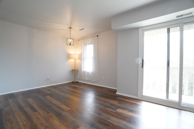 unfurnished room with wood finished floors and baseboards