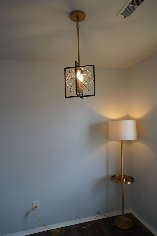 detailed view of baseboards and a chandelier