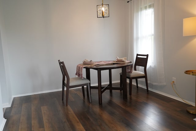 dining room featuring dark wood-style floors and baseboards