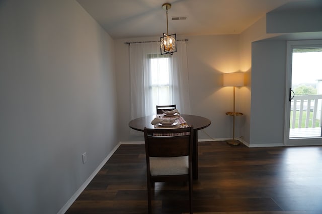 dining room with wood finished floors, a chandelier, and baseboards