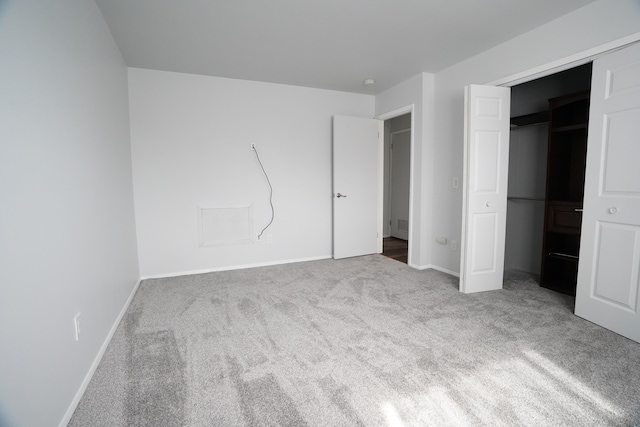 unfurnished bedroom featuring carpet, baseboards, and a closet