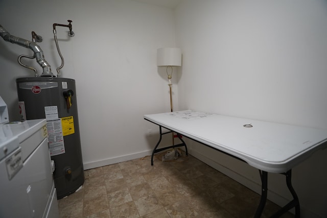 utility room with gas water heater and washer / dryer