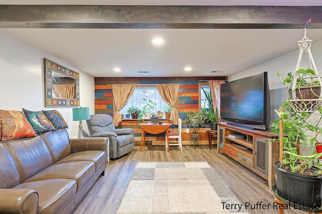 living room featuring wood finished floors, recessed lighting, and beam ceiling