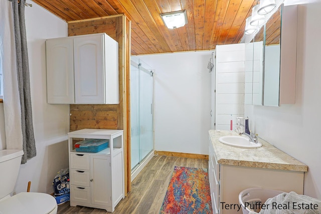 full bath with wood ceiling, wood finished floors, a shower stall, toilet, and vanity