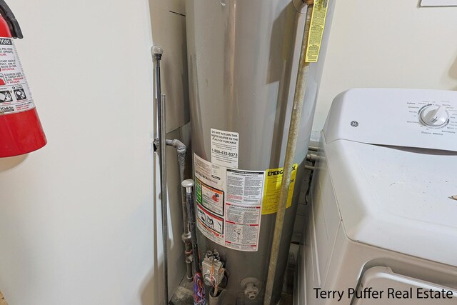 utilities featuring water heater and washer / dryer