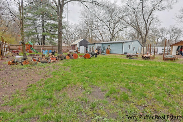 view of yard featuring a shed, an outbuilding, and a playground