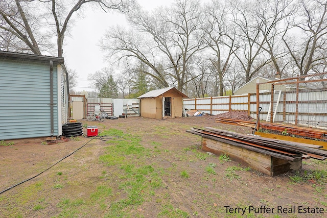 fenced backyard featuring a storage shed, an outbuilding, and central air condition unit