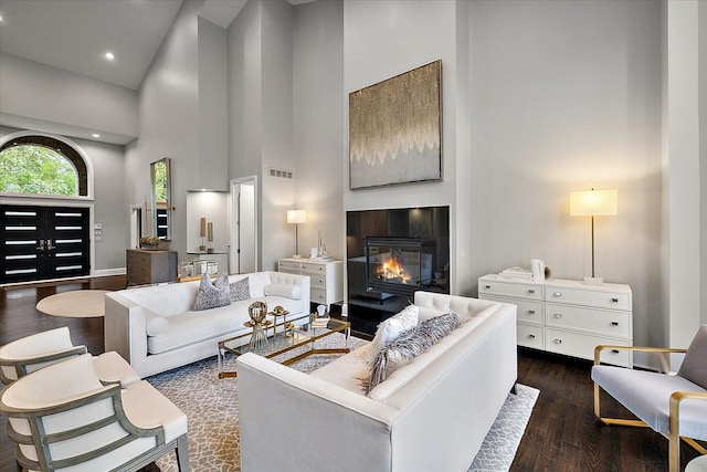 31080 Lucerne Dr, Franklin, MI 48025 - living area featuring high vaulted ceiling, dark wood-style floors, a glass covered fireplace, recessed lighting, and baseboards