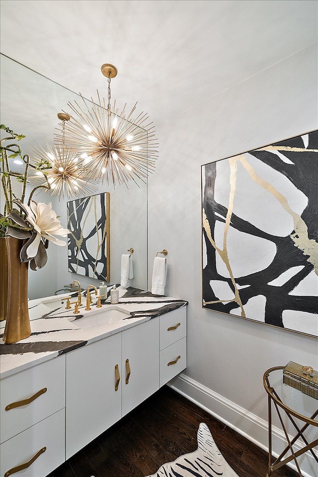 31080 Lucerne Dr, Franklin, MI 48025 - bathroom featuring wood finished floors, a chandelier, baseboards, and vanity