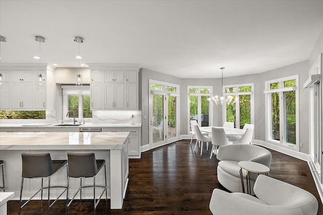 31080 Lucerne Dr, Franklin, MI 48025 - kitchen featuring a chandelier, plenty of natural light, light stone counters, white cabinets, and recessed lighting