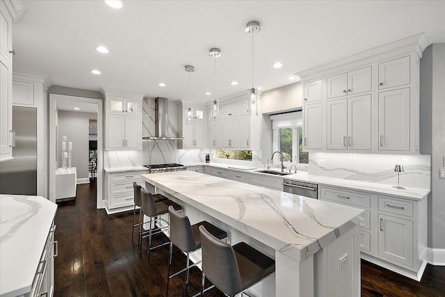 31080 Lucerne Dr, Franklin, MI 48025 - kitchen with wall chimney exhaust hood, a sink, a kitchen island, white cabinets, and recessed lighting
