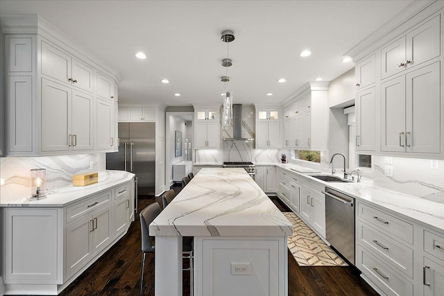 31080 Lucerne Dr, Franklin, MI 48025 - kitchen with stainless steel appliances, a sink, wall chimney range hood, a kitchen island, and backsplash