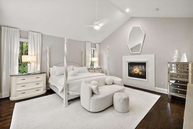 31080 Lucerne Dr, Franklin, MI 48025 - bedroom featuring dark wood finished floors, vaulted ceiling, a glass covered fireplace, baseboards, and ceiling fan