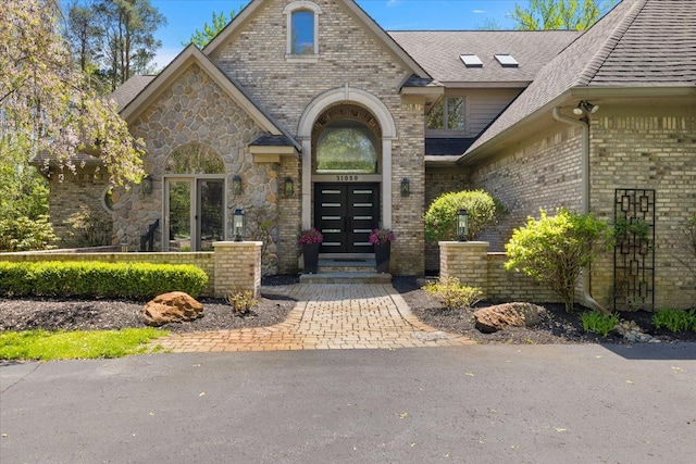 31080 Lucerne Dr, Franklin, MI 48025 - doorway to property featuring french doors, brick siding, and a shingled roof