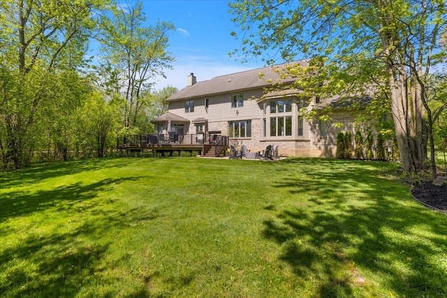 31080 Lucerne Dr, Franklin, MI 48025 - rear view of house with a wooden deck, a chimney, and a lawn