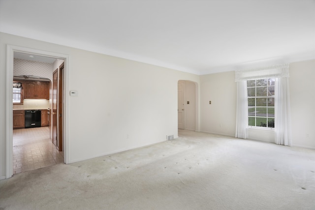 1133 Balfour St, Grosse Pointe Park, MI 48230 - spare room featuring arched walkways, light carpet, and baseboards