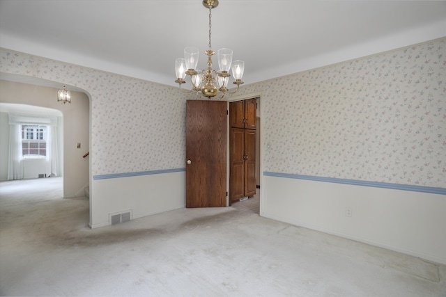 1133 Balfour St, Grosse Pointe Park, MI 48230 - unfurnished room featuring wallpapered walls, a chandelier, carpet flooring, and arched walkways